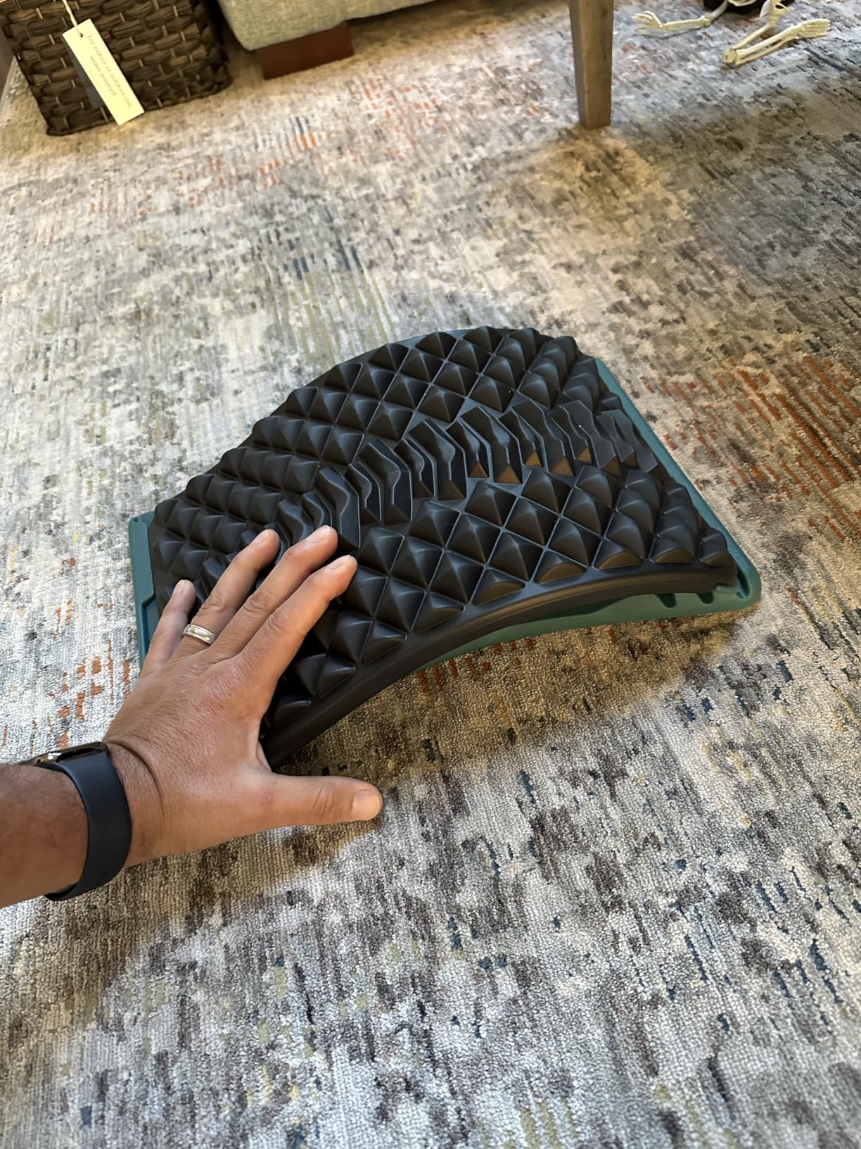 A person lies on the floor using the LTUMHGCR Back Stretcher for comfort and support during their stretching routine.