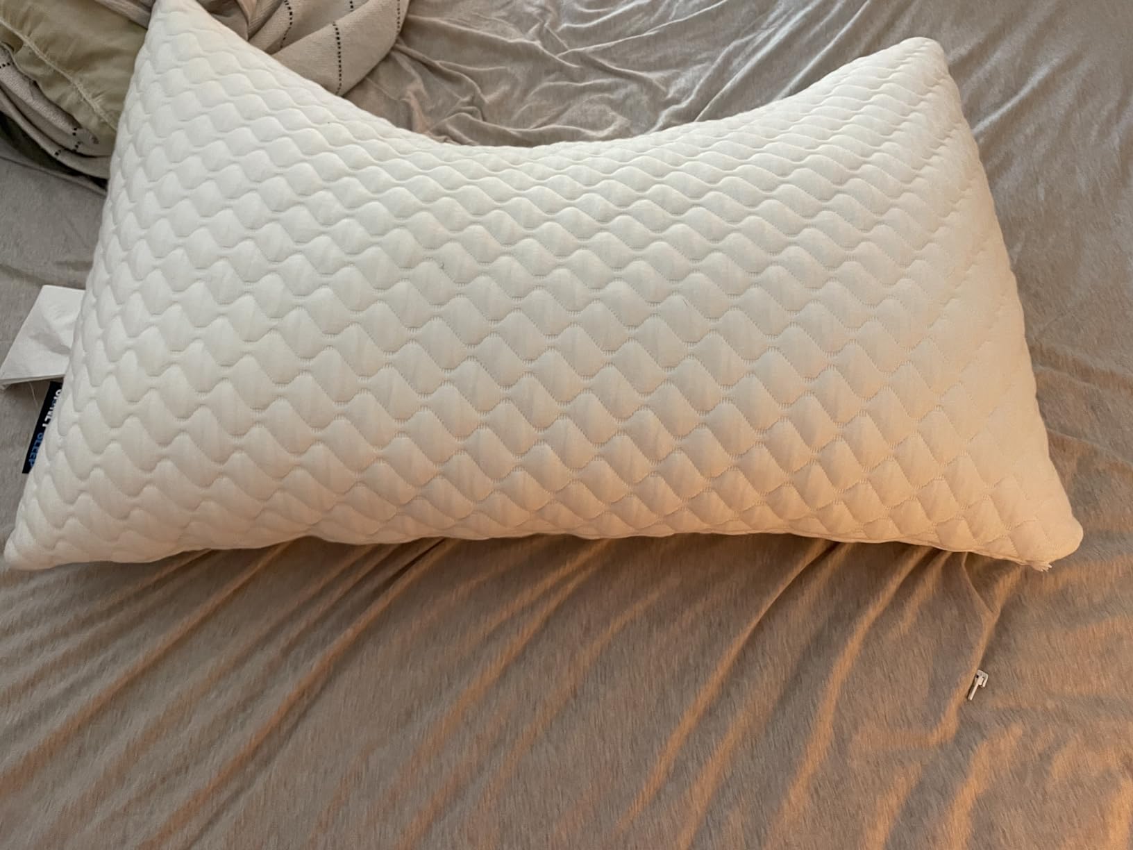 The Sidney Sleep Pillow looks like a quilt, offering a soft and inviting touch for a comfortable sleeping experience.