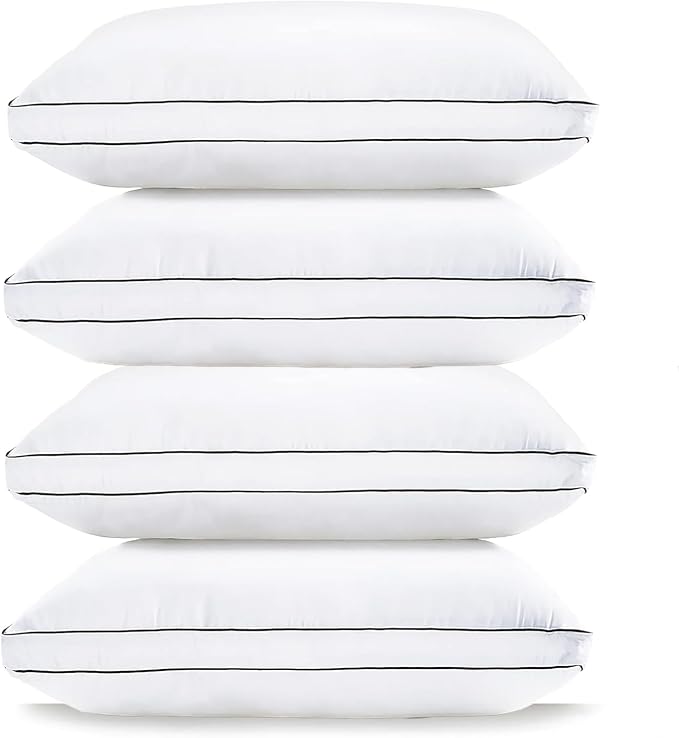Four LANE LINEN Standard Pillows stacked neatly on top of each other, showcasing their soft and comfortable design.