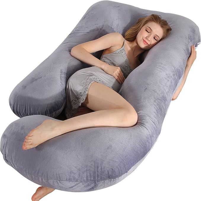 A woman relaxing on a large pillow, enjoying comfort with the BATTOP Pregnancy Pillow.
